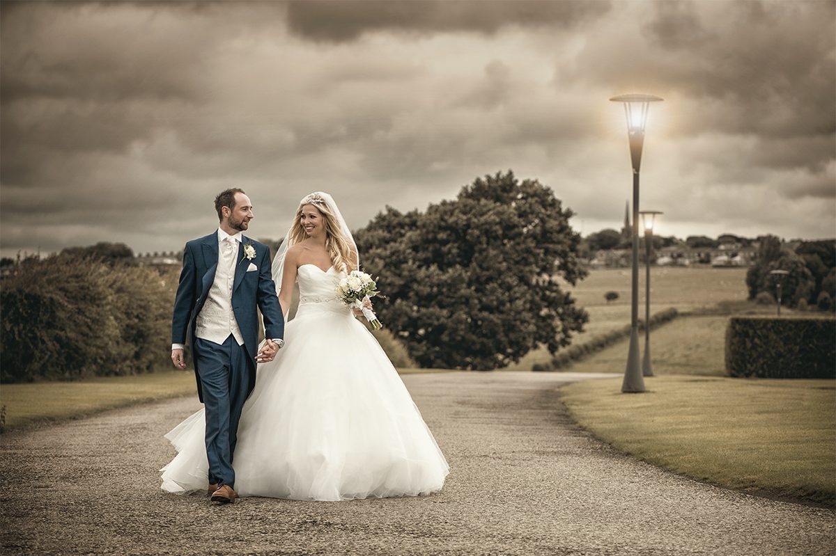 Bride and groom walking holding hands